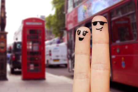 family, couple, travel, tourism and body parts concept - close up of two fingers with smiley faces over london city street backgroundの写真素材