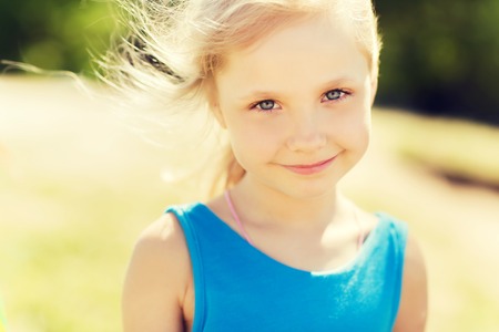 summer, childhood, leisure and people concept - happy little girl outdoorsの写真素材