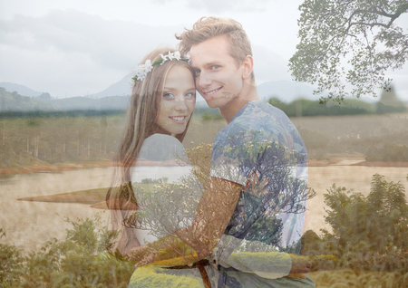 summer holidays, love, romance and people concept - happy smiling young hippie couple hugging over natural background with double exposure effectの写真素材