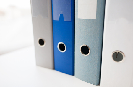 business, document, paperwork, office supply and education concept - close up of ring binders on...