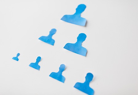 business, people, employment, career and hiring concept - close up of paper human shapes on white boardの写真素材