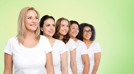 friendship, diverse, body positive and people concept - group of happy different size women in white t-shirts over green natural backgroundの写真素材