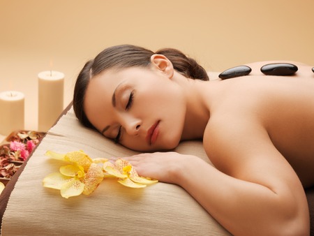 picture of woman in spa salon with hot stonesの写真素材