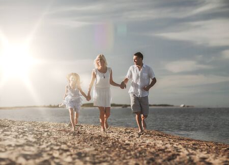 summer holidays, children and people concept - happy family at the seasideの写真素材