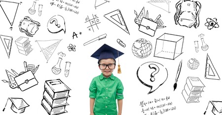 childhood, school, education, learning and people concept - happy boy in bachelor hat or mortarboard with doodlesの写真素材