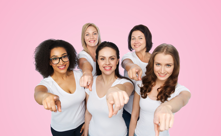 choice, friendship, body positive, gesture and people concept - group of happy different size women in white t-shirts pointing finger on you over pink backgroundの写真素材