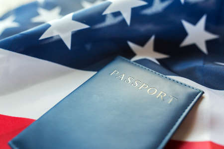 citizenship, patriotism and nationalism concept - close up of american flag and passportの写真素材