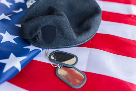 military forces, service, patriotism and nationalism concept - close up of american flag, soldiers badges and paratrooper hatの写真素材