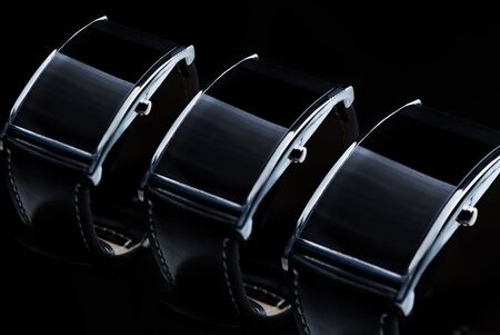 modern technology, time, object and media concept - close up of black smart watch or wristwatch setの写真素材