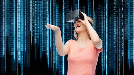 technology, virtual reality, entertainment and people concept - happy young woman with virtual...