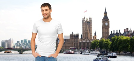 travel, tourism and people concept - smiling man in blank white t-shirt over london city backgroundの写真素材