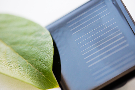 recycling, energy, power, environment and ecology concept - close up of solar battery or cell