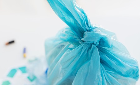 waste recycling, reuse, garbage disposal, environment and ecology concept - close up of rubbish bag with trash or garbage at homeの写真素材