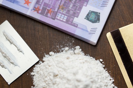 drug use, crime, addiction and substance abuse concept - close up of crack cocaine drug dose track on mirror with credit card and moneyの写真素材