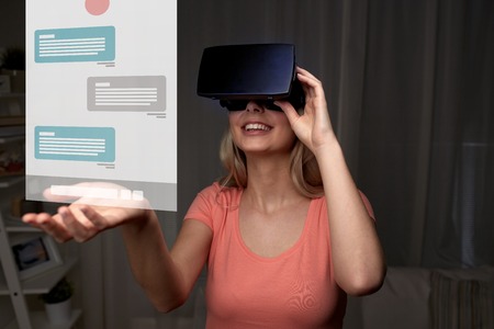 technology, virtual reality, cyberspace, entertainment and people concept - happy young woman with...
