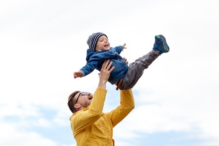 family, childhood, fatherhood, leisure and people concept - happy father and little son playing and having fun outdoorsの写真素材