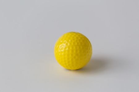 sport, fitness, game, sports equipment and objects concept - close up of yellow golf ballの写真素材