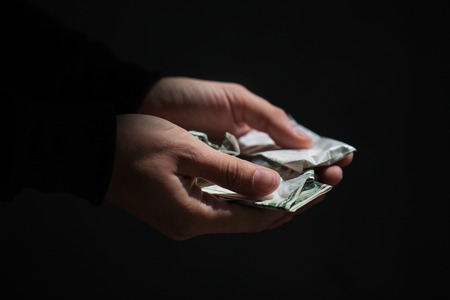 drug trafficking, crime, addiction and sale concept - close up of addict hands with drugs and moneyの写真素材