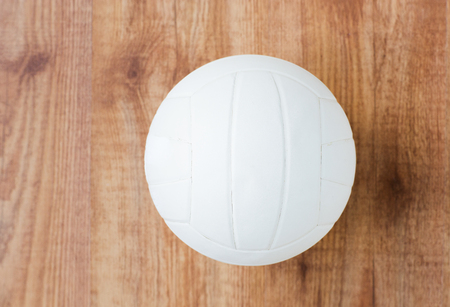 sport, fitness, game, sports equipment and objects concept - close up of volleyball ball on wooden floor from topの写真素材