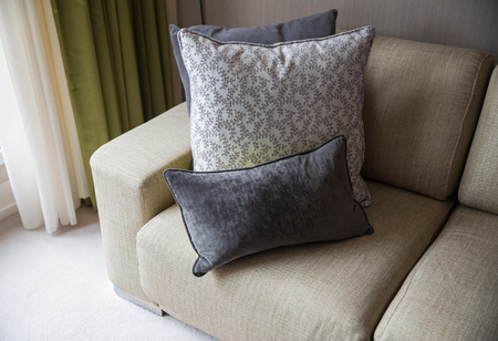 comfort, furniture and interior concept - close up of couch with cushions at home living room