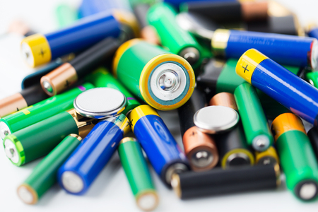 recycling, energy, power, environment and ecology concept - close up of alkaline batteries heapの写真素材
