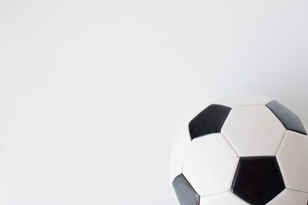 sport, football and sports equipment concept - close up of soccer ball over white background from topの写真素材