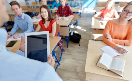 education, high school, teaching, technology and people concept - group of happy students and...