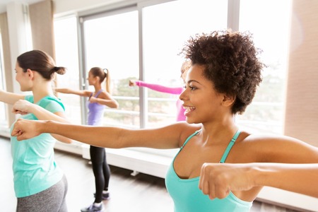 fitness, sport, training, people and martial arts concept - group of happy women working out...
