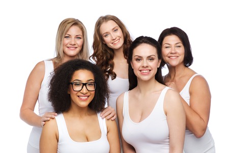 friendship, beauty, body positive and people concept - group of different happy women in white underwearの写真素材