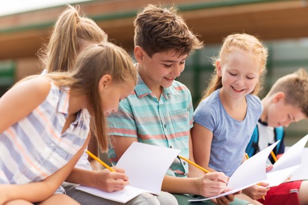 primary education, friendship, childhood, communication and people concept - group of happy...