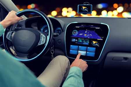 transport, destination, modern technology and people concept - close up of man driving car with navigation system on board computerの写真素材
