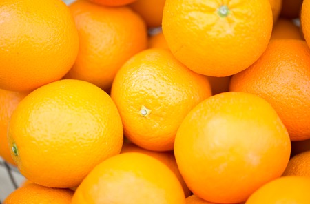 vegetarian food, fruits and citrus concept - close up of fresh ripe juicy oranges