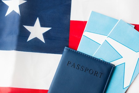 travel, tourism, emigration and visa concept - american national flag, passport and air ticketsの写真素材