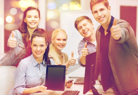 education, advertisement, techology and internet concept - group of smiling students with computer...