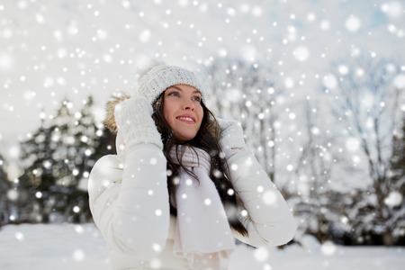 people, season and leisure concept - happy woman outdoors in winterの写真素材
