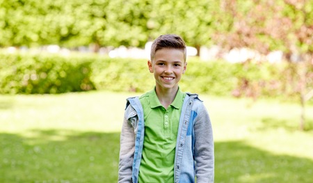 childhood and people concept - happy smiling boy at summer parkの写真素材