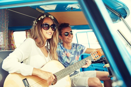 summer holidays, road trip, vacation, travel and people concept - smiling young hippie couple with...