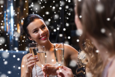 celebration, friends, bachelorette party and holidays concept - happy women with champagne glasses at night clubの写真素材