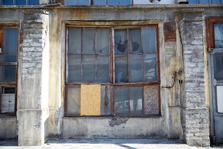 architecture and construction concept - old industrial building with broken glass windowの写真素材