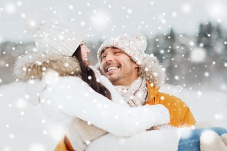 people, season, love and leisure concept - happy couple outdoors in winterの写真素材