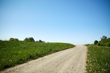 trip, travel and countryside concept - country road at summerの写真素材