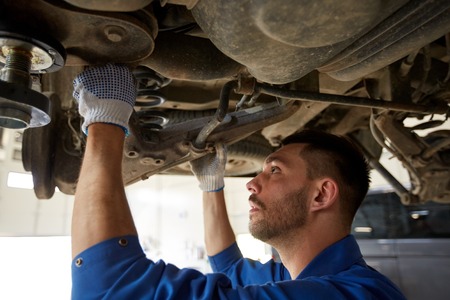 car service, repair, maintenance and people concept - auto mechanic man or smith working at workshopの写真素材