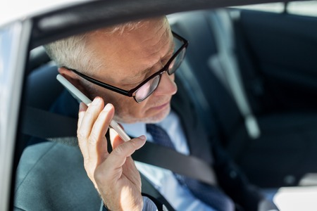 transport, business trip, technology and people concept - senior businessman calling on smartphone...