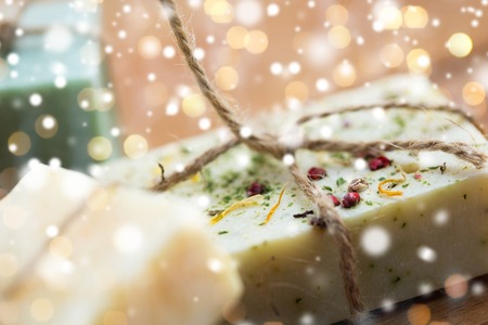 beauty, spa, bodycare, bath and natural cosmetics concept - close up of handmade soap bars over...