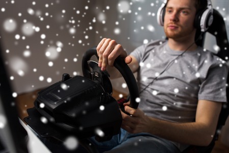 technology, gaming, entertainment, let's play and people concept - young man in headphones with pc...