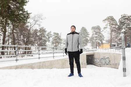 fitness, sport, people, exercising and healthy lifestyle concept - young man in winter outdoors