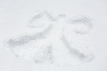 winter holidays and christmas concept - angel silhouette or print on snow surfaceの写真素材
