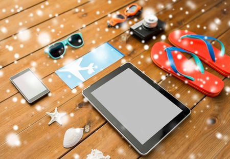 tablet pc, airplane ticket and beach stuffの写真素材