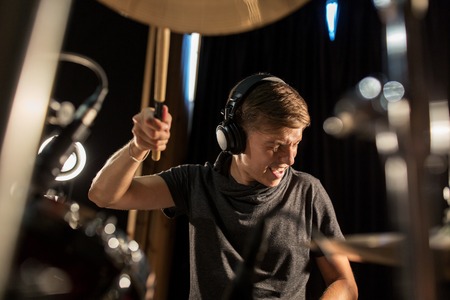 male musician playing drums and cymbals at concert