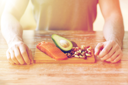 close up of male hands with food rich in proteinの写真素材